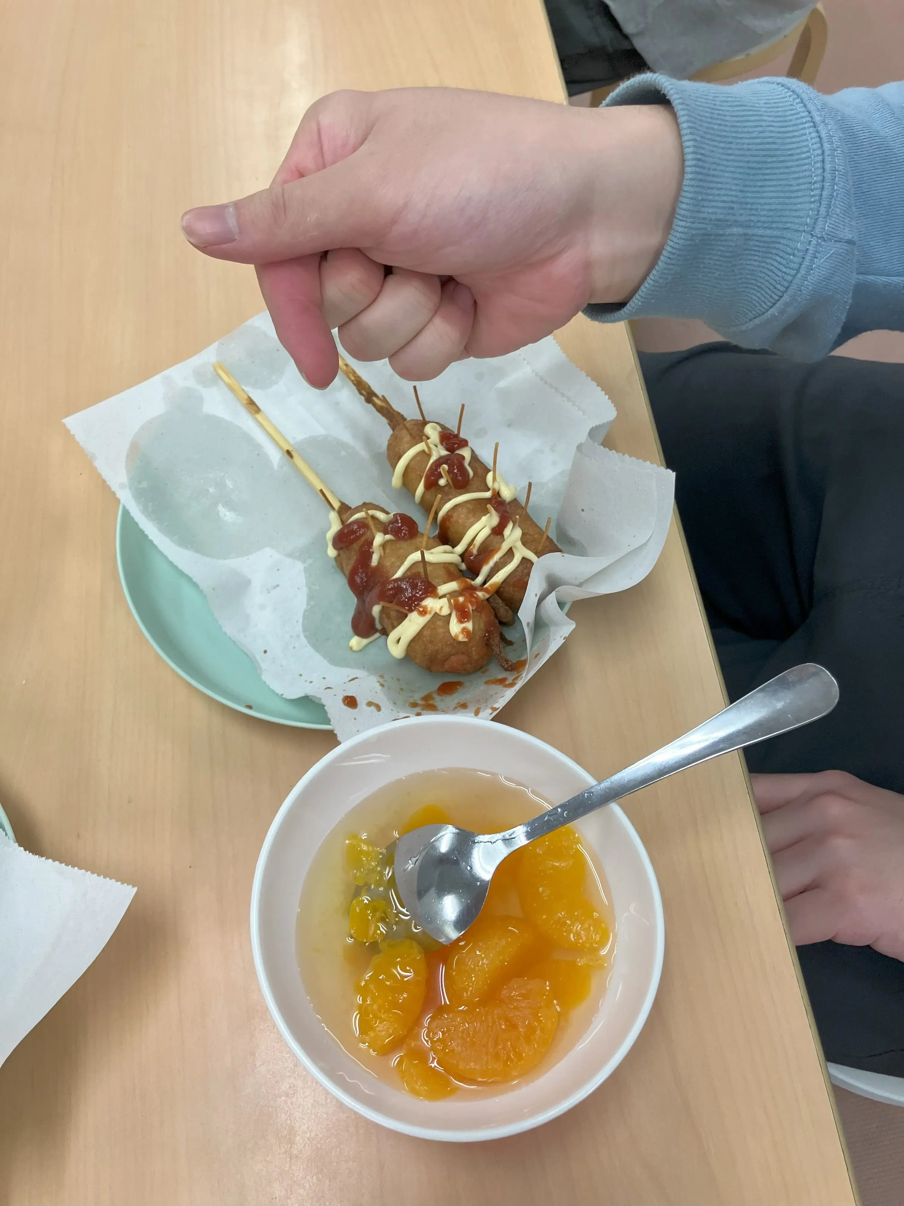 アメリカンドッグが完成し、食べる場面